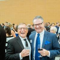 Guests laughing before the Enrichment Dinner.